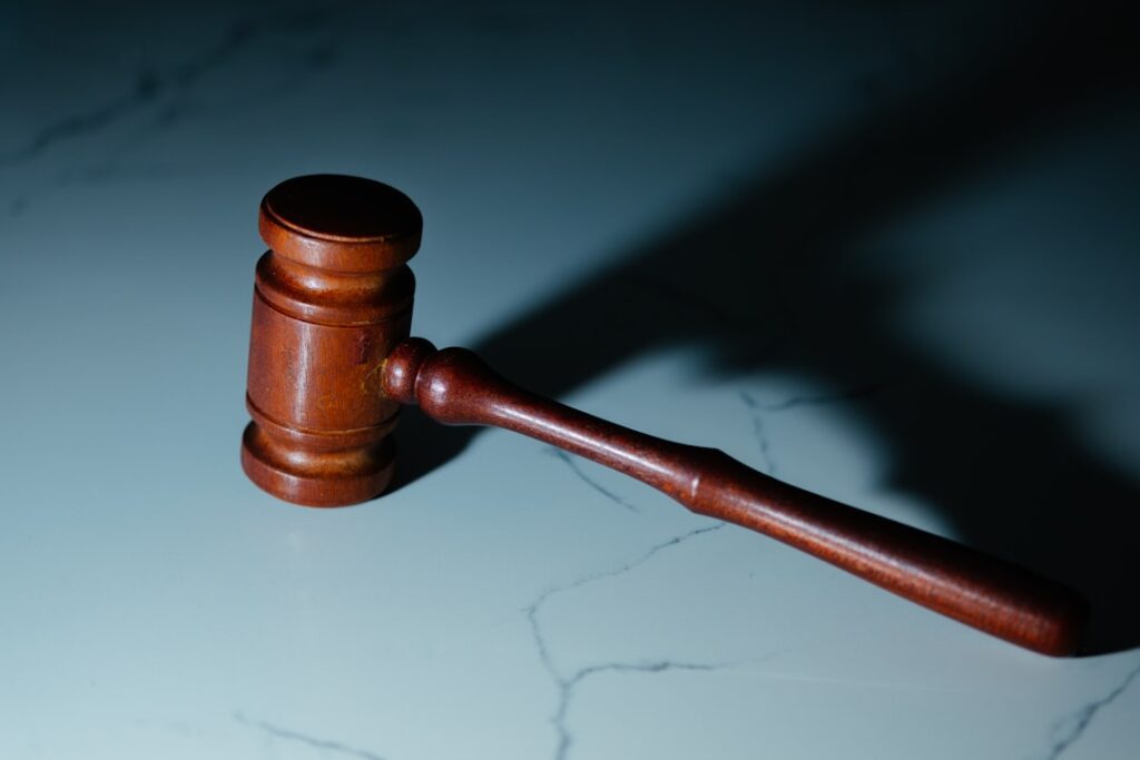 A judge's gavel resting on a wooden table